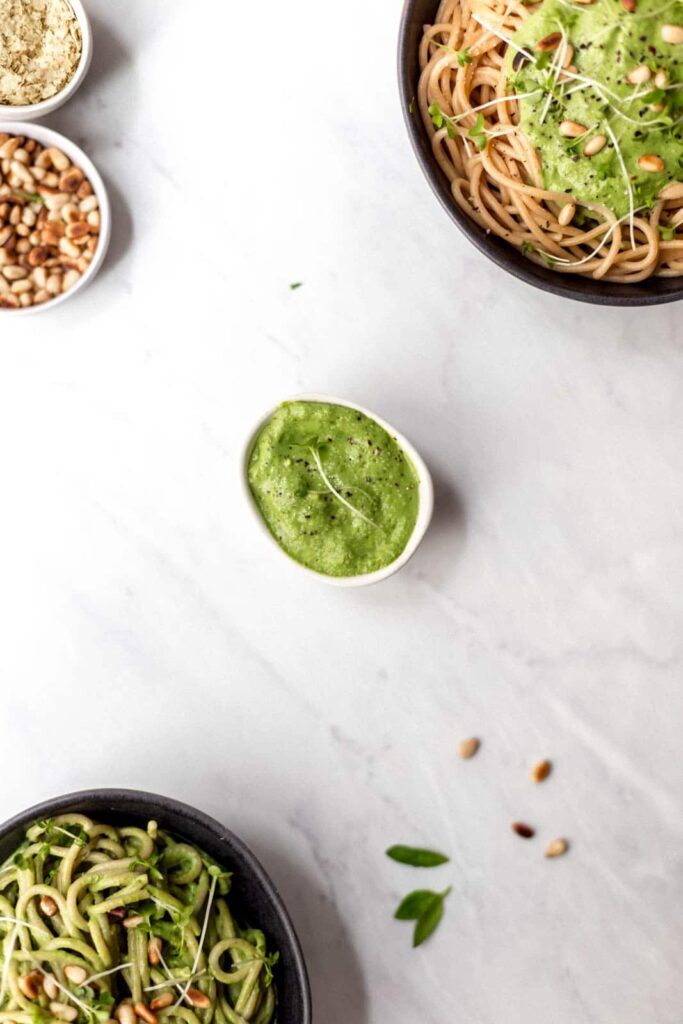 A small bowl of creamy green pasta sauce.