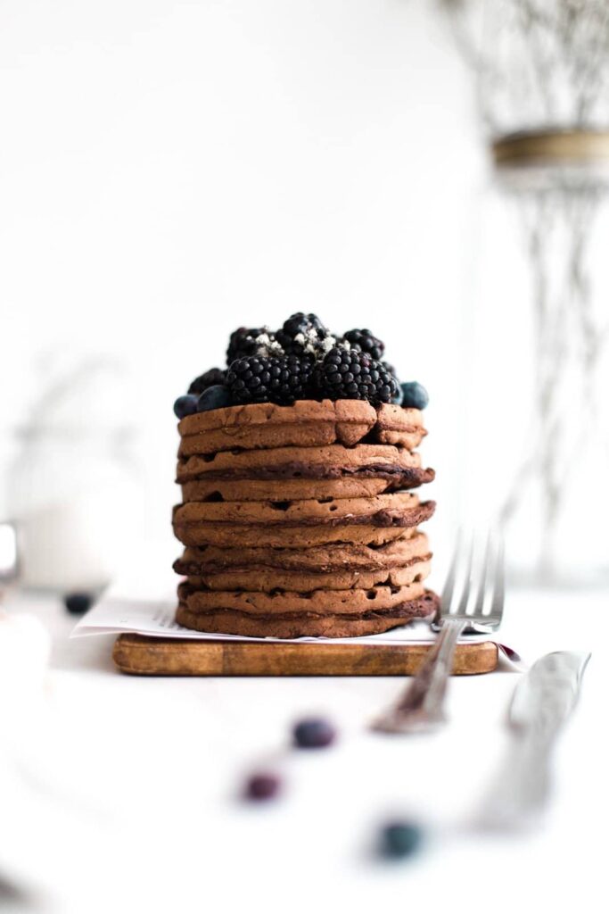 A stack of waffles topped with berries