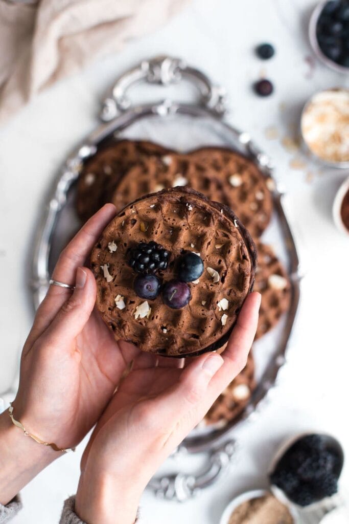 Chocolate waffle held in two hands