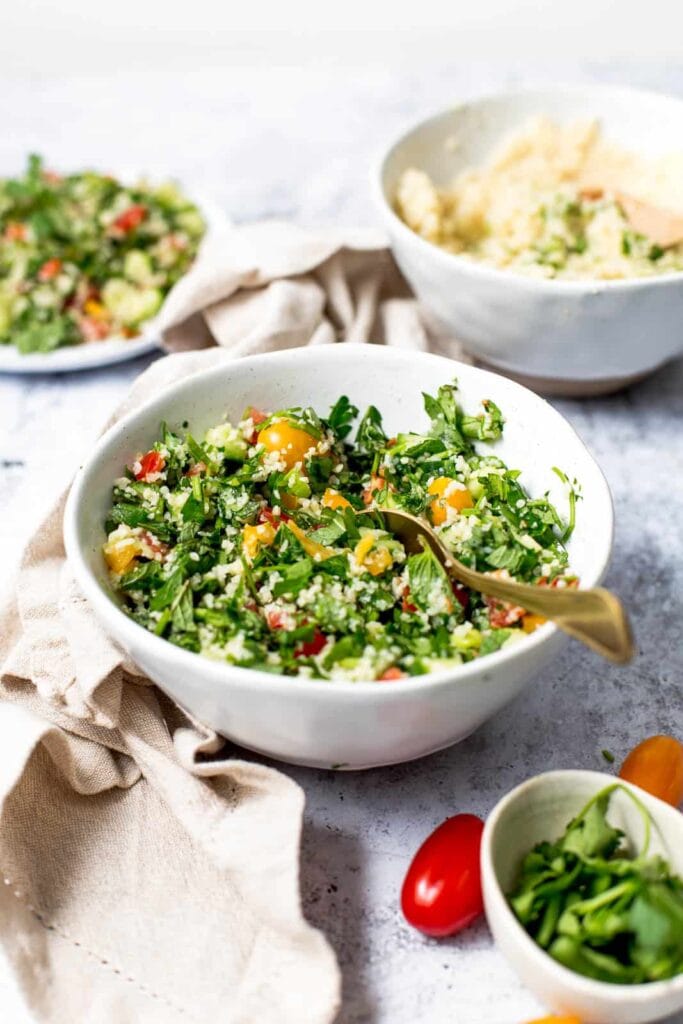 Side view of tabbouleh salad in a large white bowl.