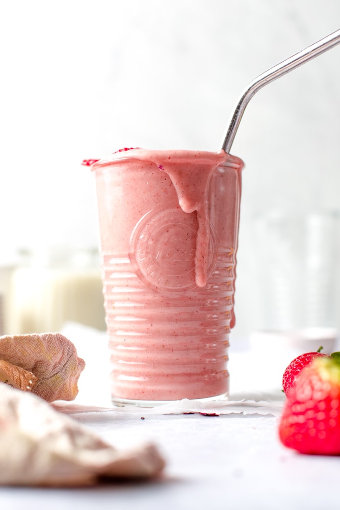 A full glass of pink smoothie. 