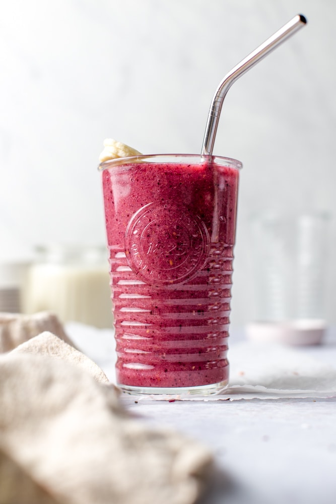 A full glass of mixed berry smoothie. 