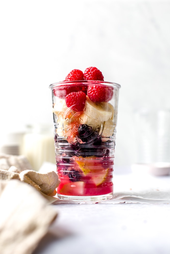 All the ingredients need to make a smoothie placed in a glass. 