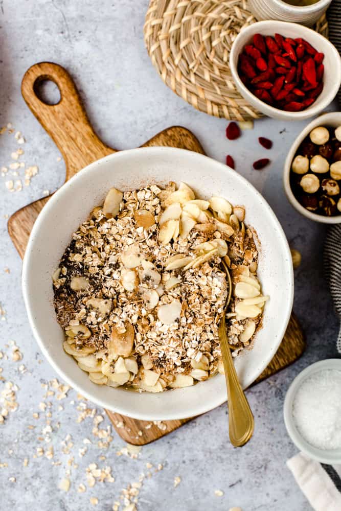 Various nuts and seeds in a small white bowl. 