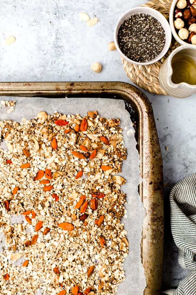 Lined baking tray full of freshly made granola. 