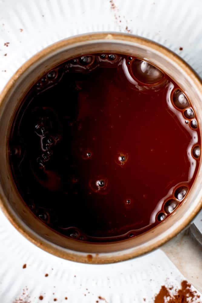 A close-up overhead view of hot chocolate in a mug.