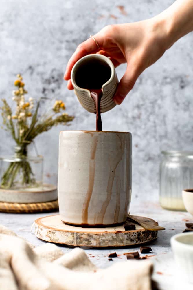 Hot chocolate being poured into a mug.