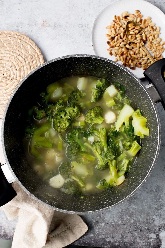 Broccoli, potato and garlic in a large pan.