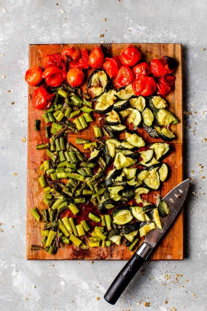 Roasted vegetables on a large wooden cutting board. 