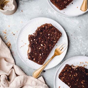 Slices of banana bread placed on several round plates.