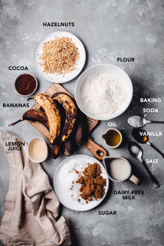 All ingredients needed to make vegan banana bread laid out on a flat surface.