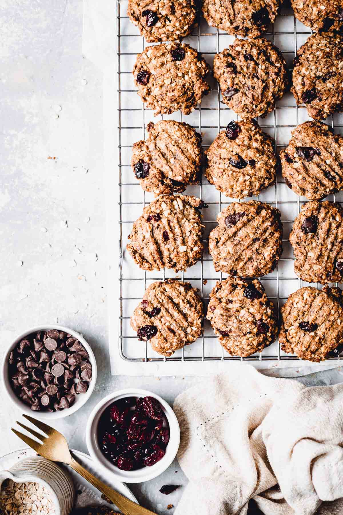 Baked oatmeal cookies laying flat on a cooling rack.