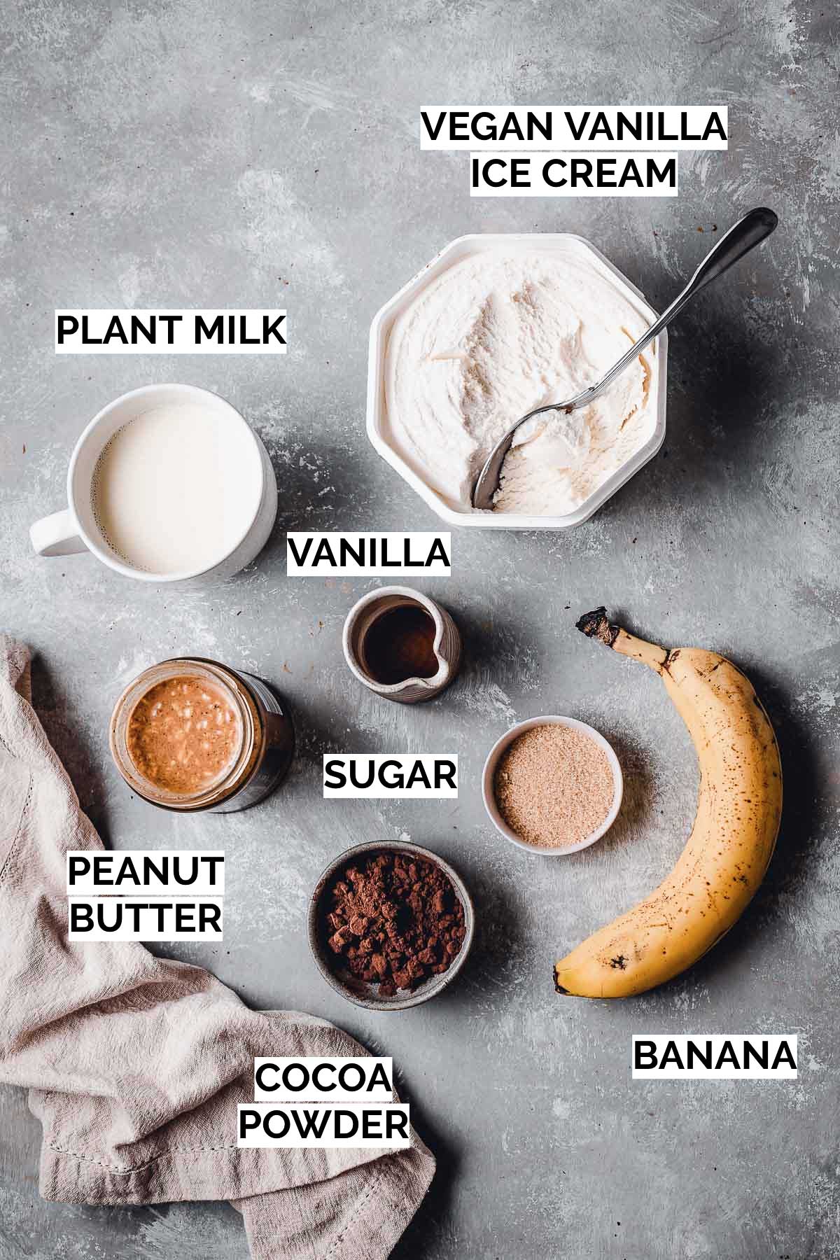 All ingredients needed to make a chocolate shake laid out on a flat surface. 