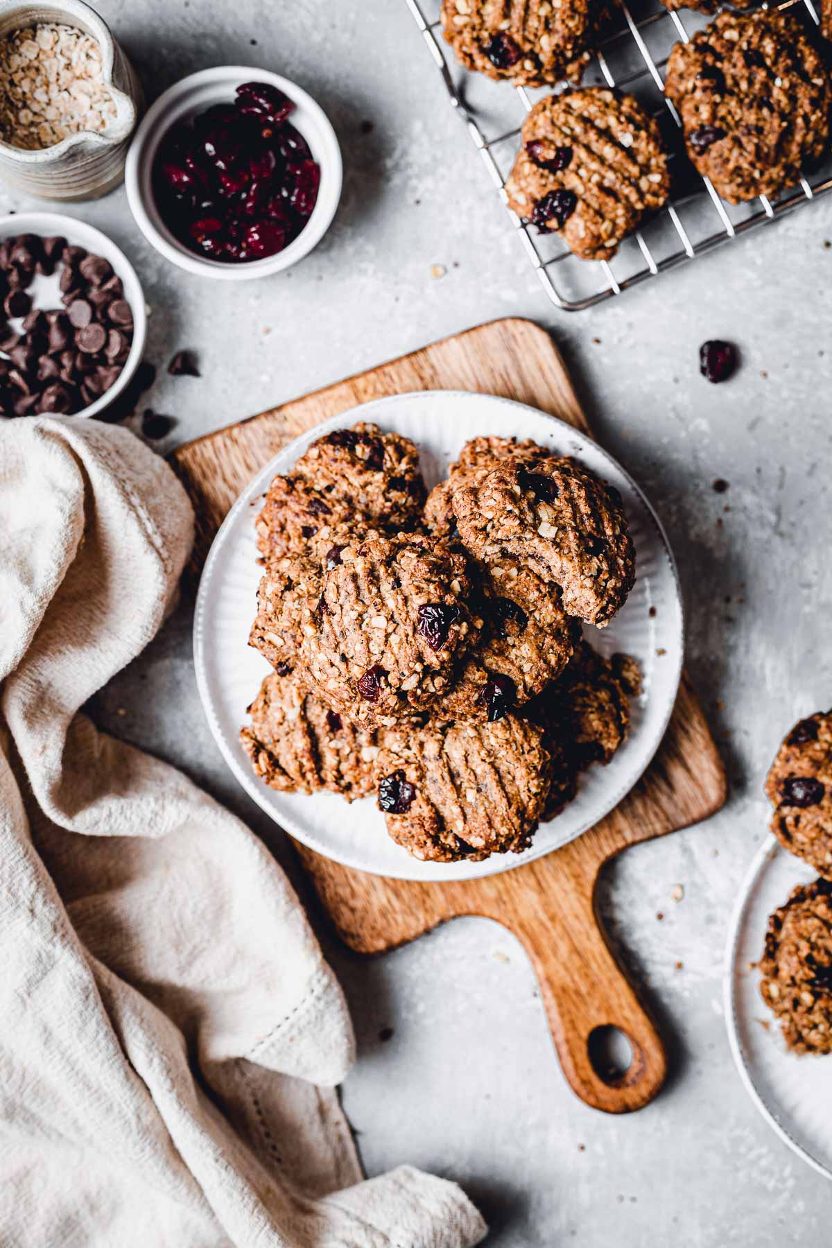 A plate full of oatmeal cookies laid flat on a wooden board. 