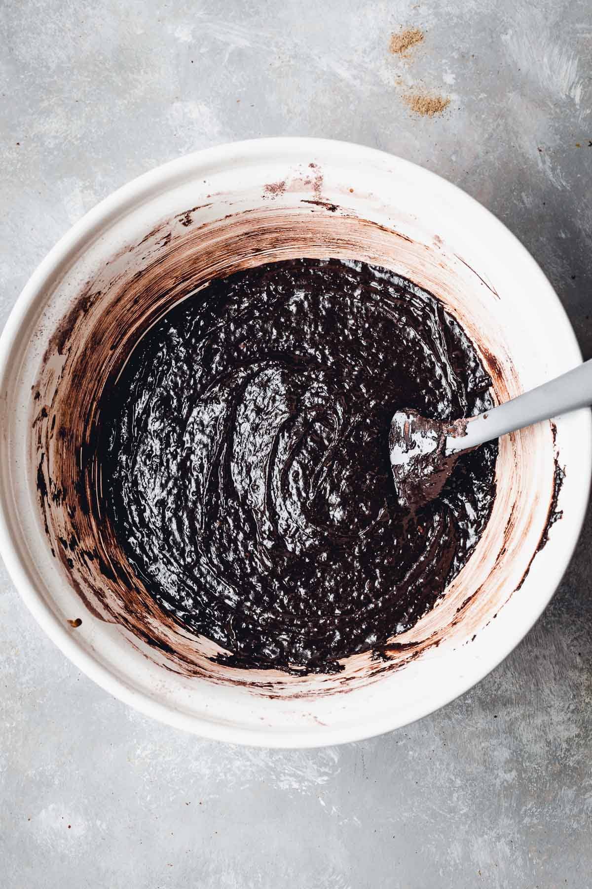 A large mixing bowl full of glossy brownie batter. 