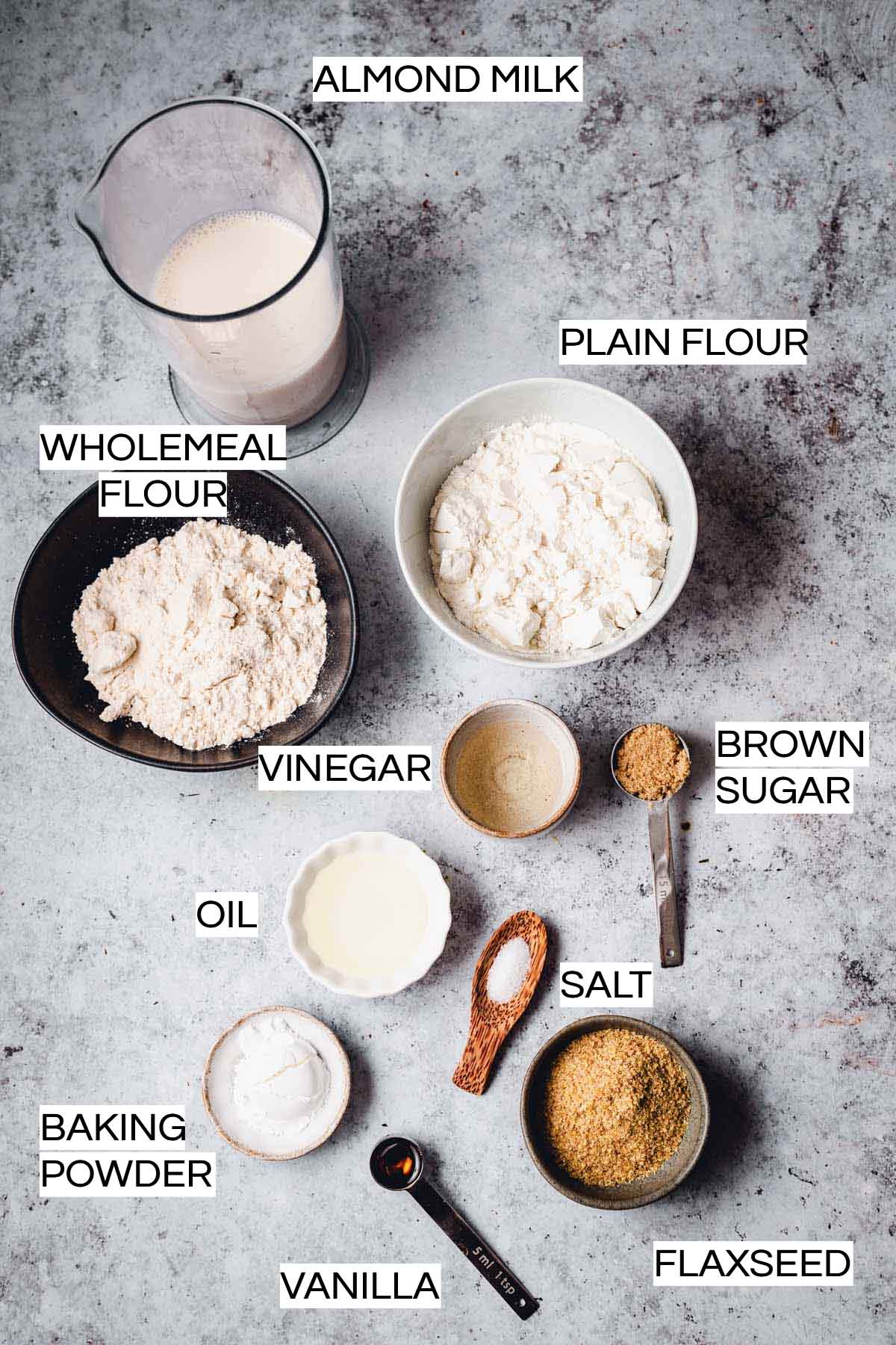 All ingredients needed to make waffles laid out on plates and bowls. 