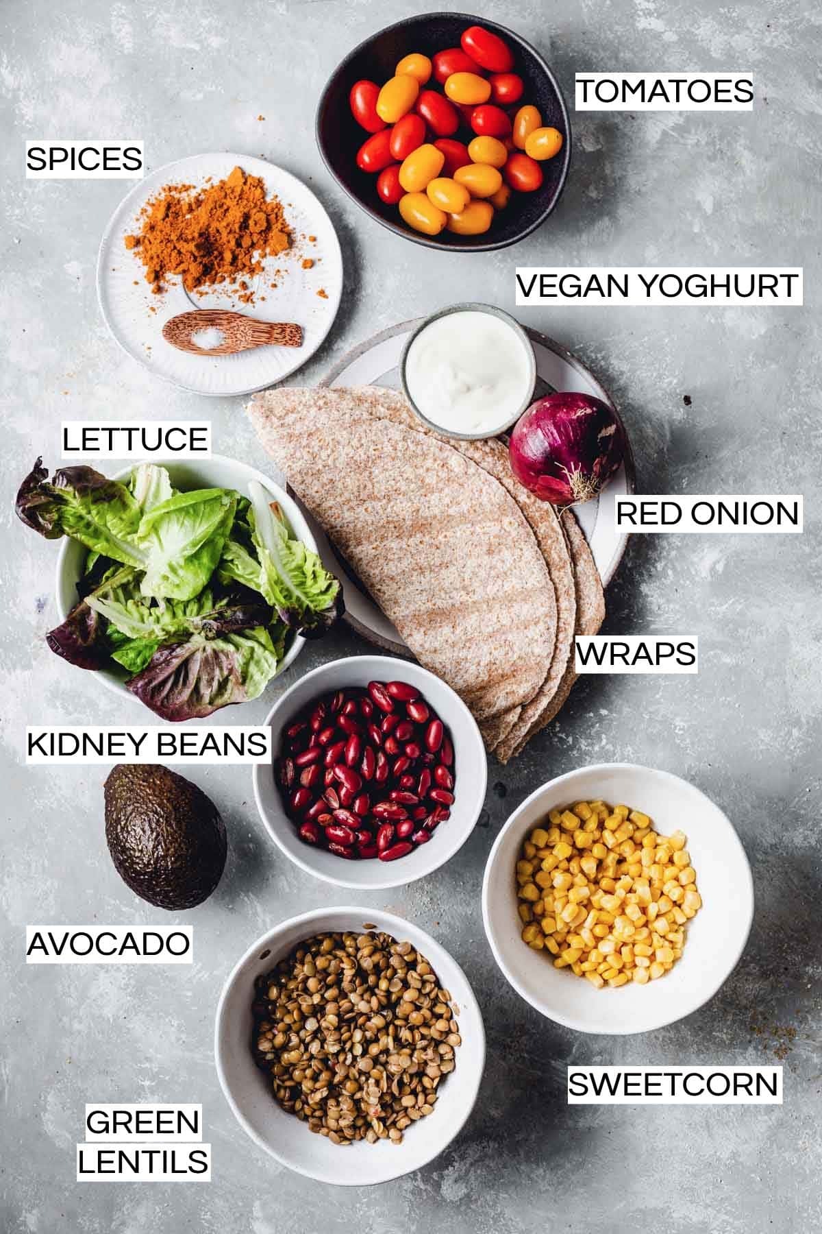 Various vegetables and other ingredients laid out in bowls and on plates. 