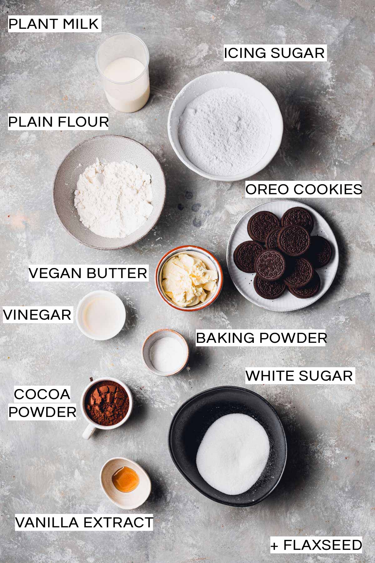All ingredients needed to bake Oreo cupcakes laid out in bowls on