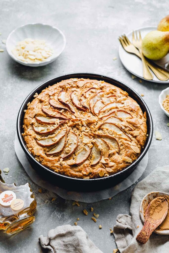 A side view of a baked cake inside a round cake tin. 