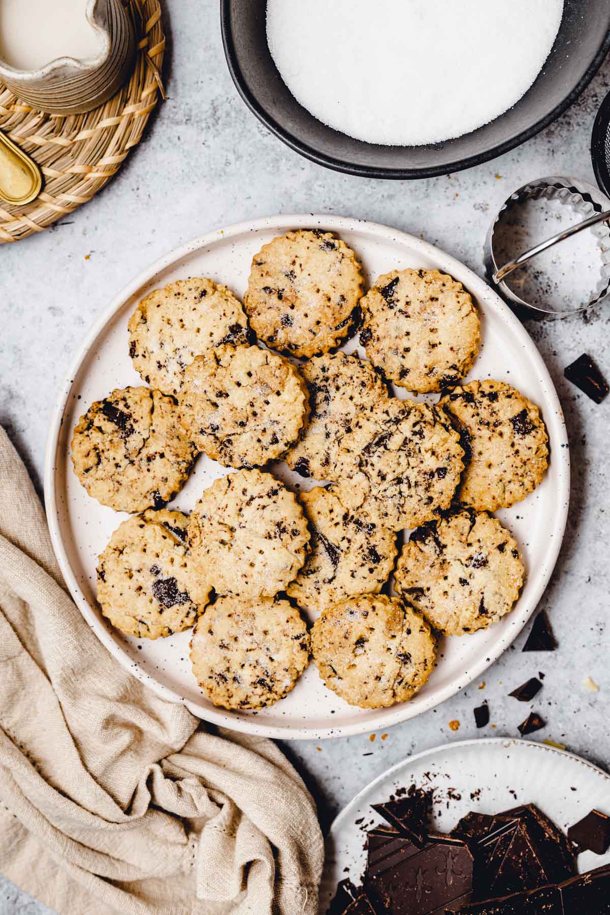 A round plate filled with chocolate shortbread cookies. 