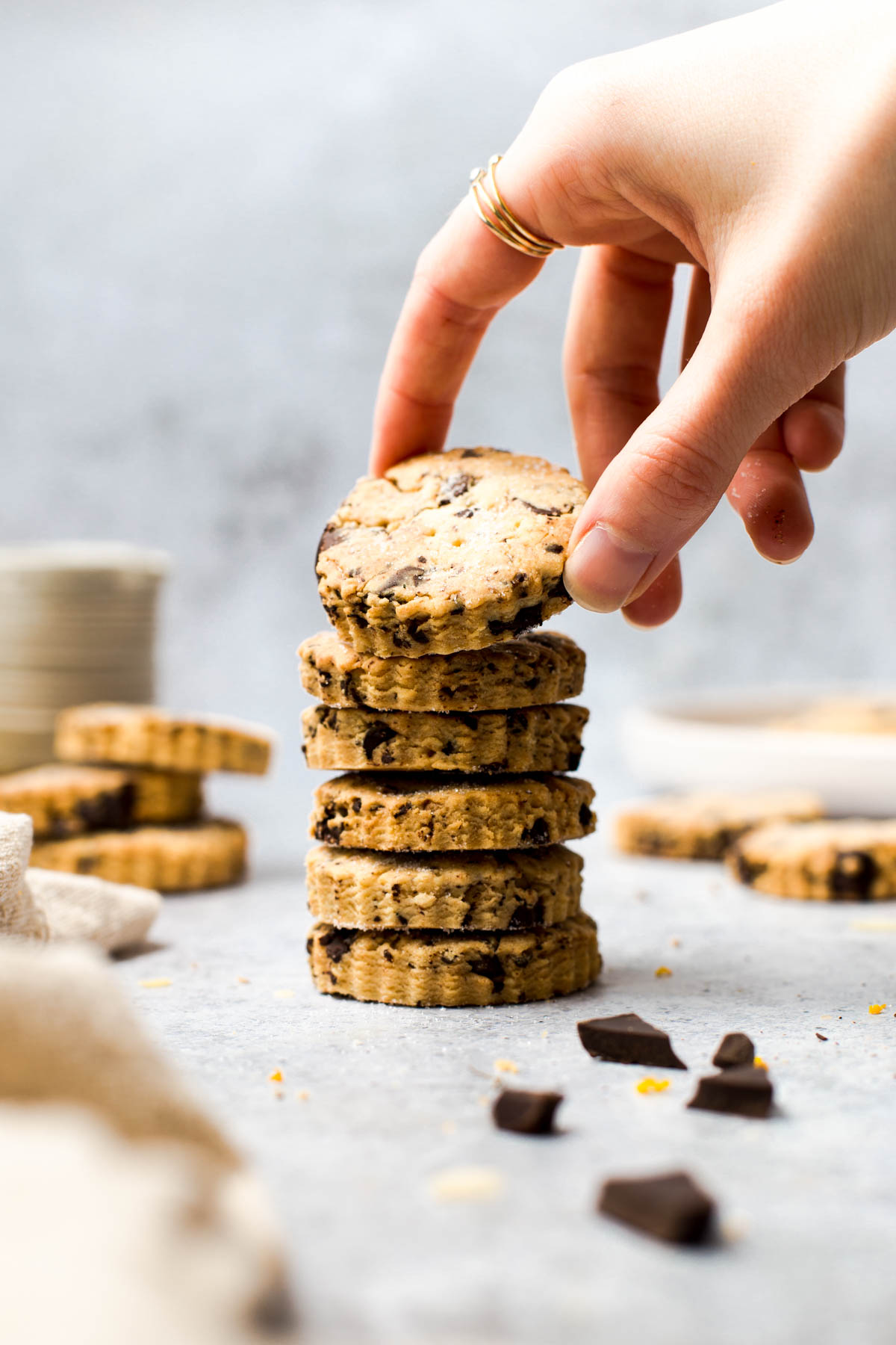 A hand reaching out for a stack of shortbread biscuits.