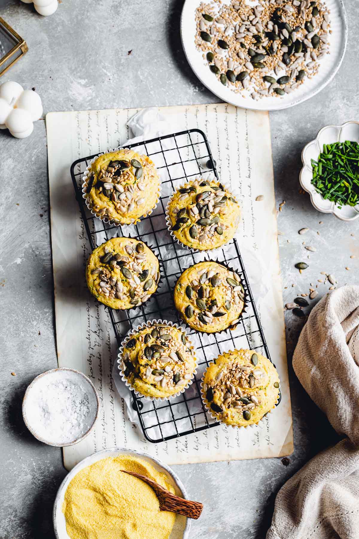 Six polenta muffins placed on a small cooling rack. 