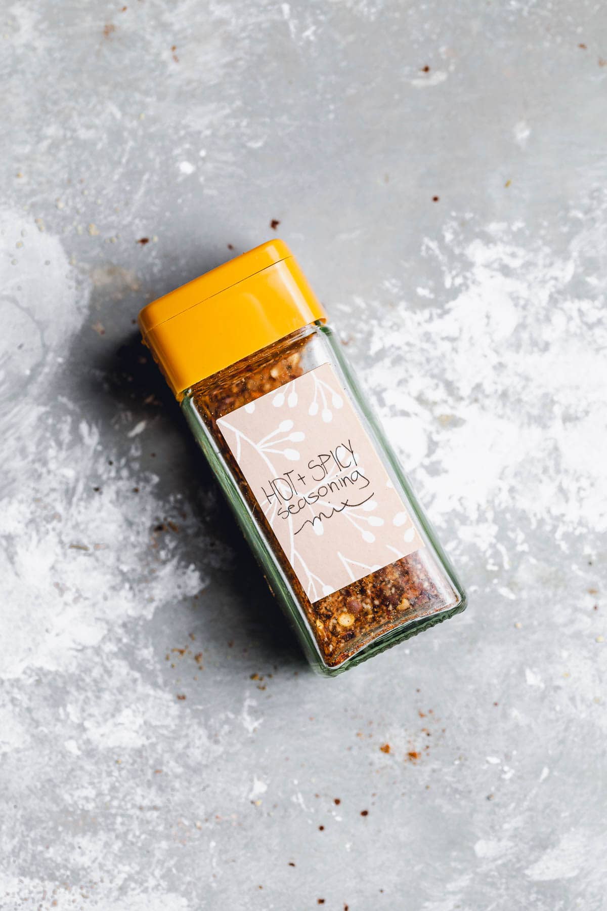 A Hot & Spicy seasoning mix placed lying down on a flat surface.