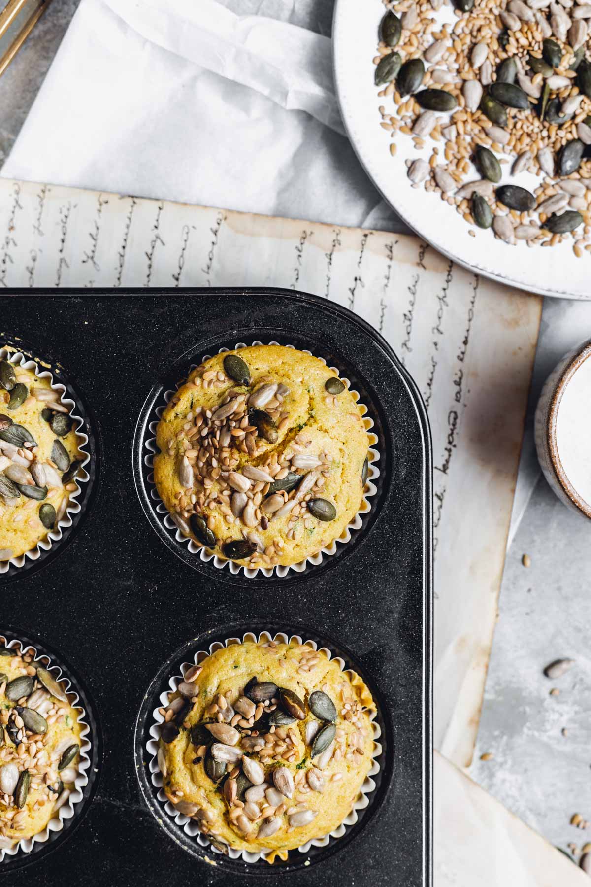 An overhead view of corn seed muffins in a cupcake tin. 