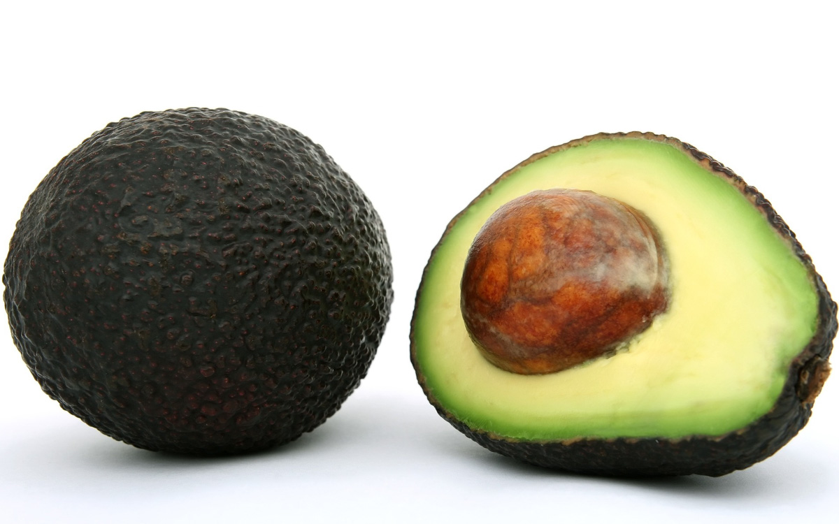 Two avocados isolated on a white background.