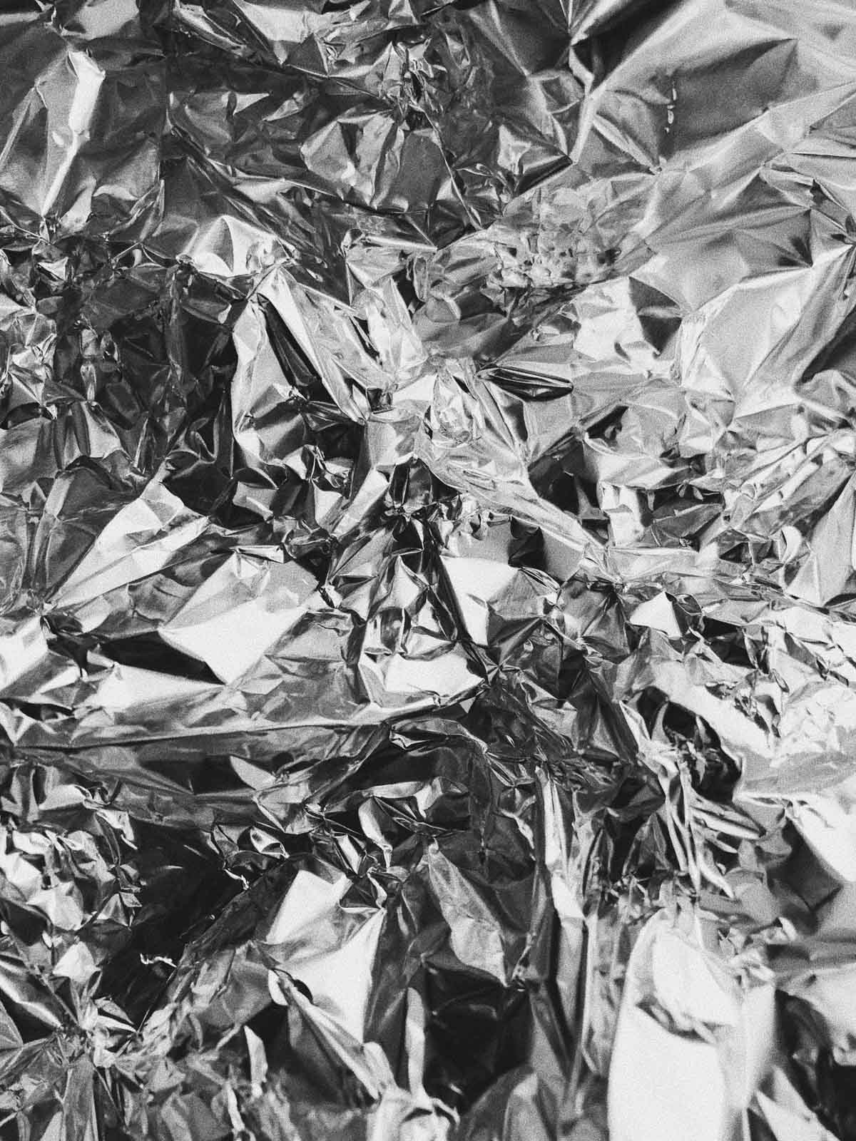 A close-up image of slightly scrunched up alu foil.