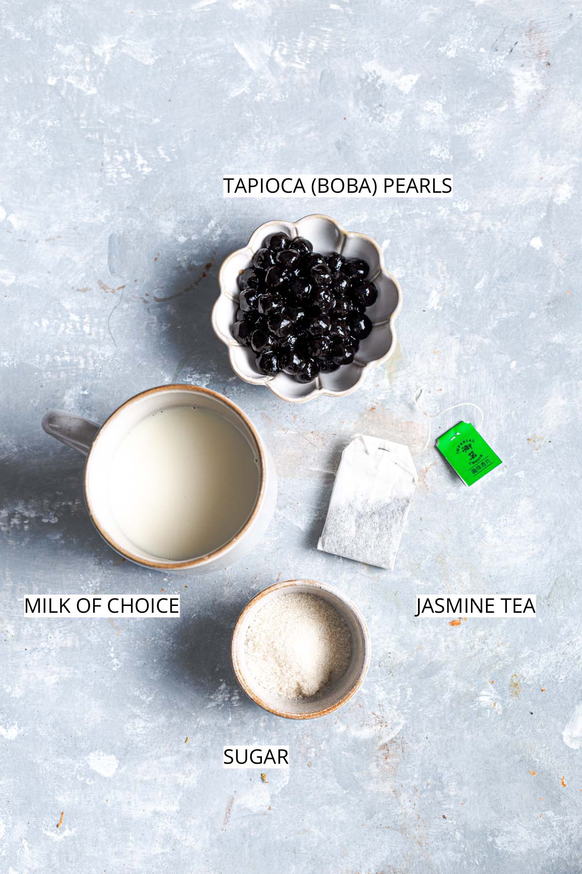 An overhead view of all ingredients needed to make jasmine milk tea.