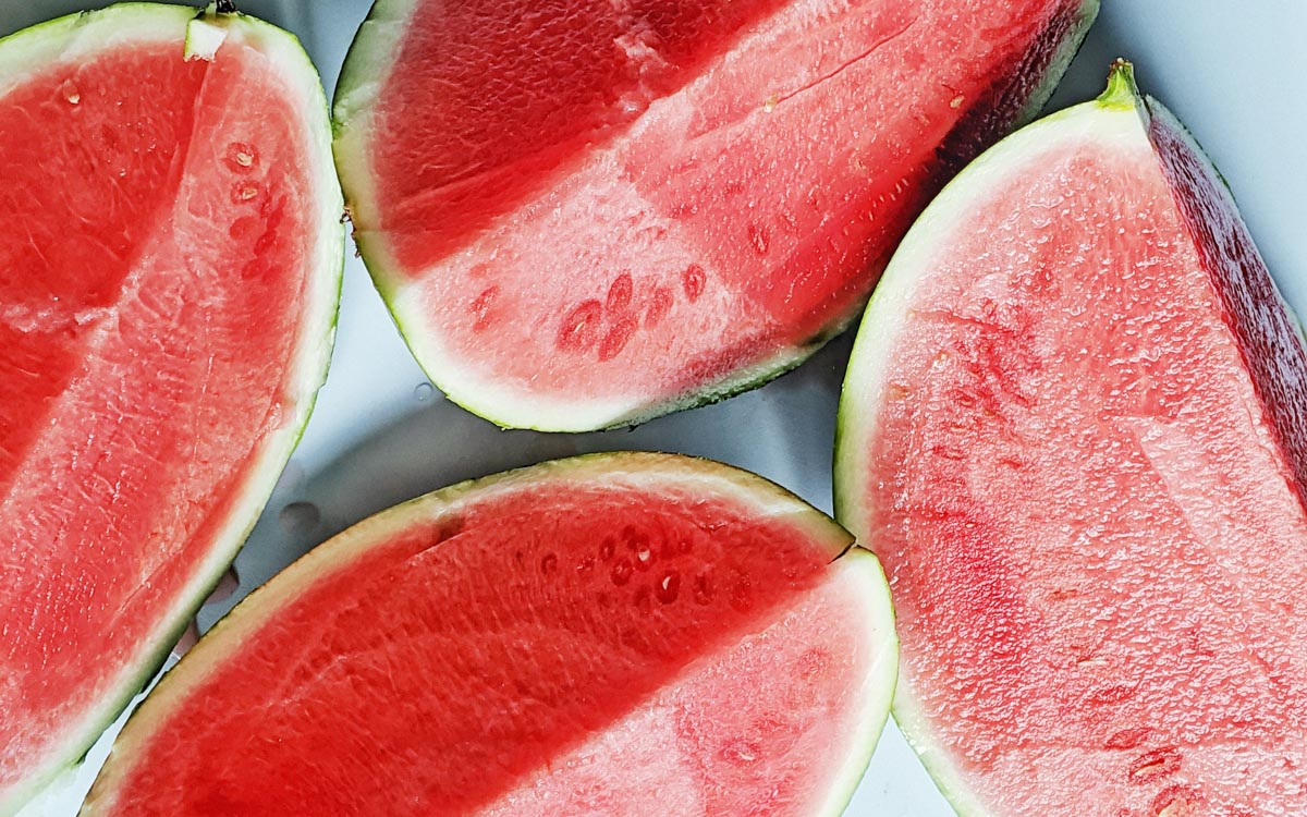 A close-up image of various slices of watermelon.