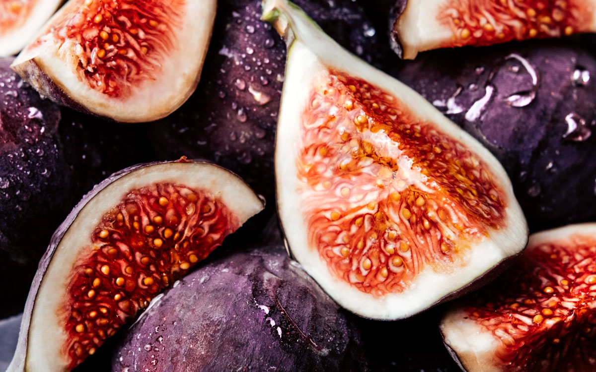 A close-up image of many slices of figs next to each other.