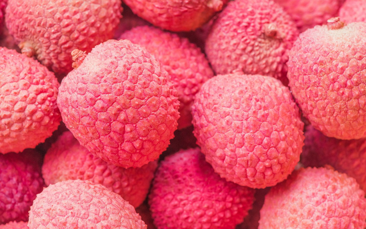 A close-up image of many lychees next to each other.