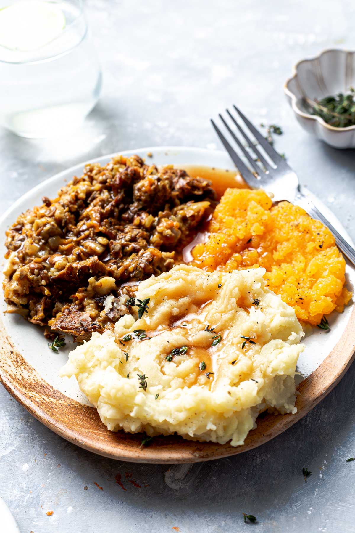 A side view of a plate of haggis with neeps and tatties.