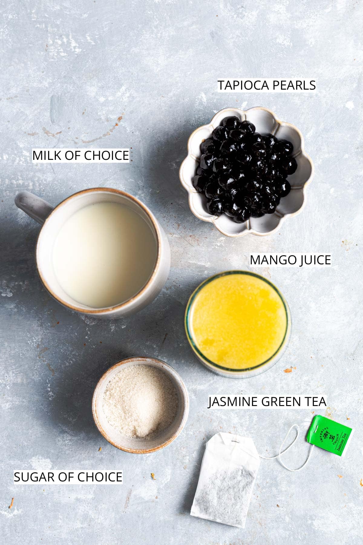 Ingredients needed to make homemade mango milk tea.