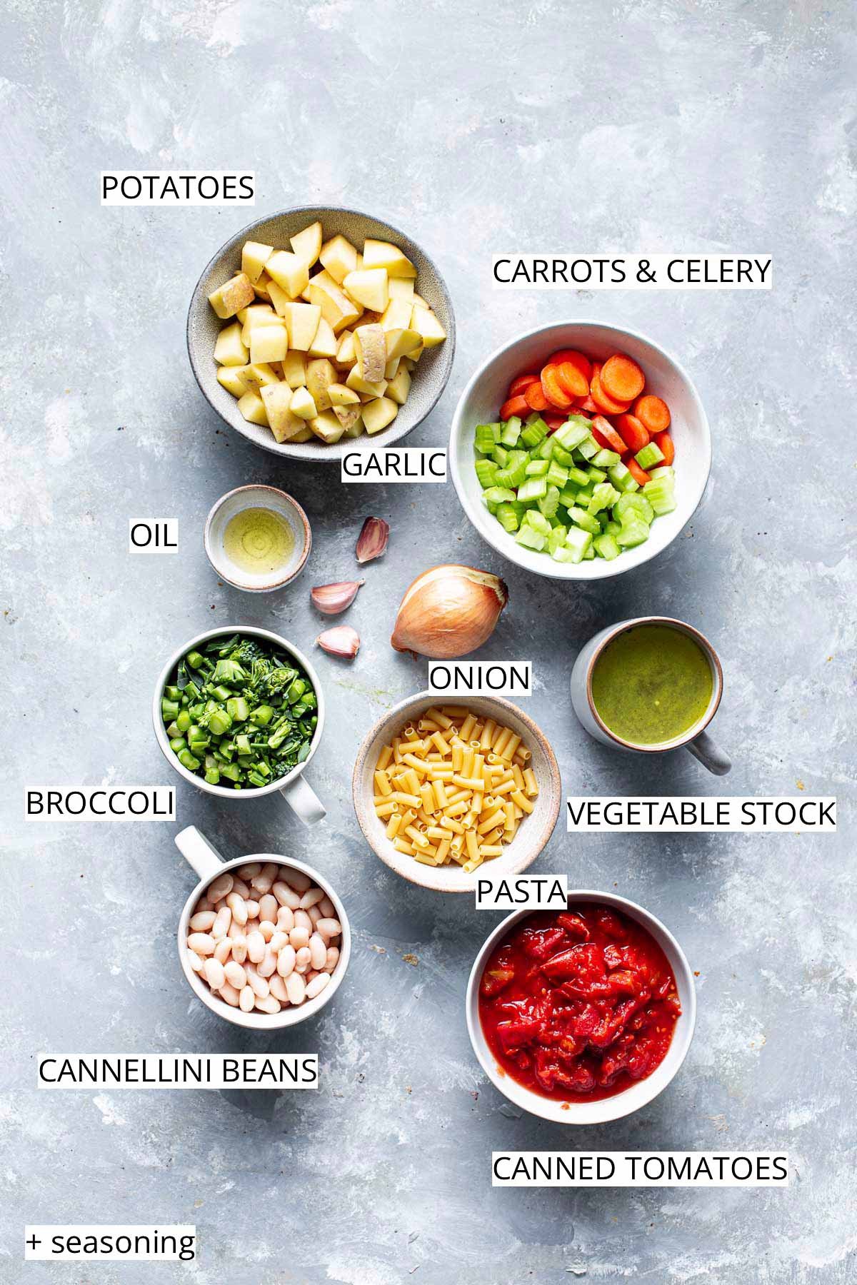 All ingredients needed to make veggie soup laid out in different bowls. 