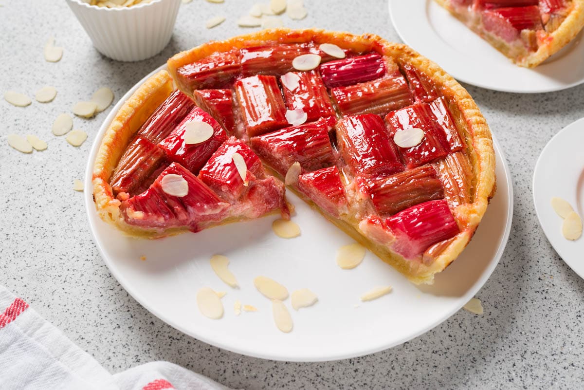 Healthy homemade summer dessert, vegan rhubarb pie on a large white plate.