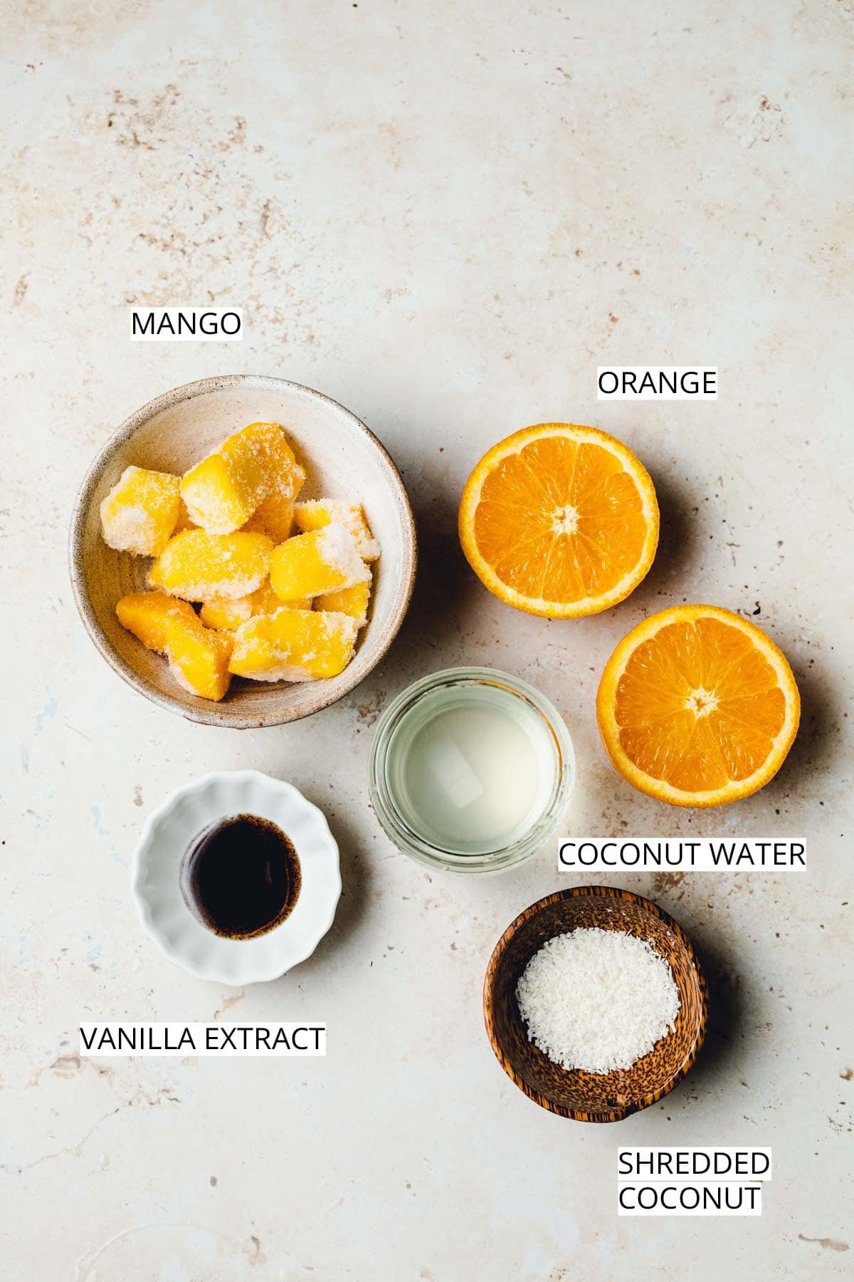 An overhead image of various ingredients needed to make a Thermomix smoothie placed next to each other. 