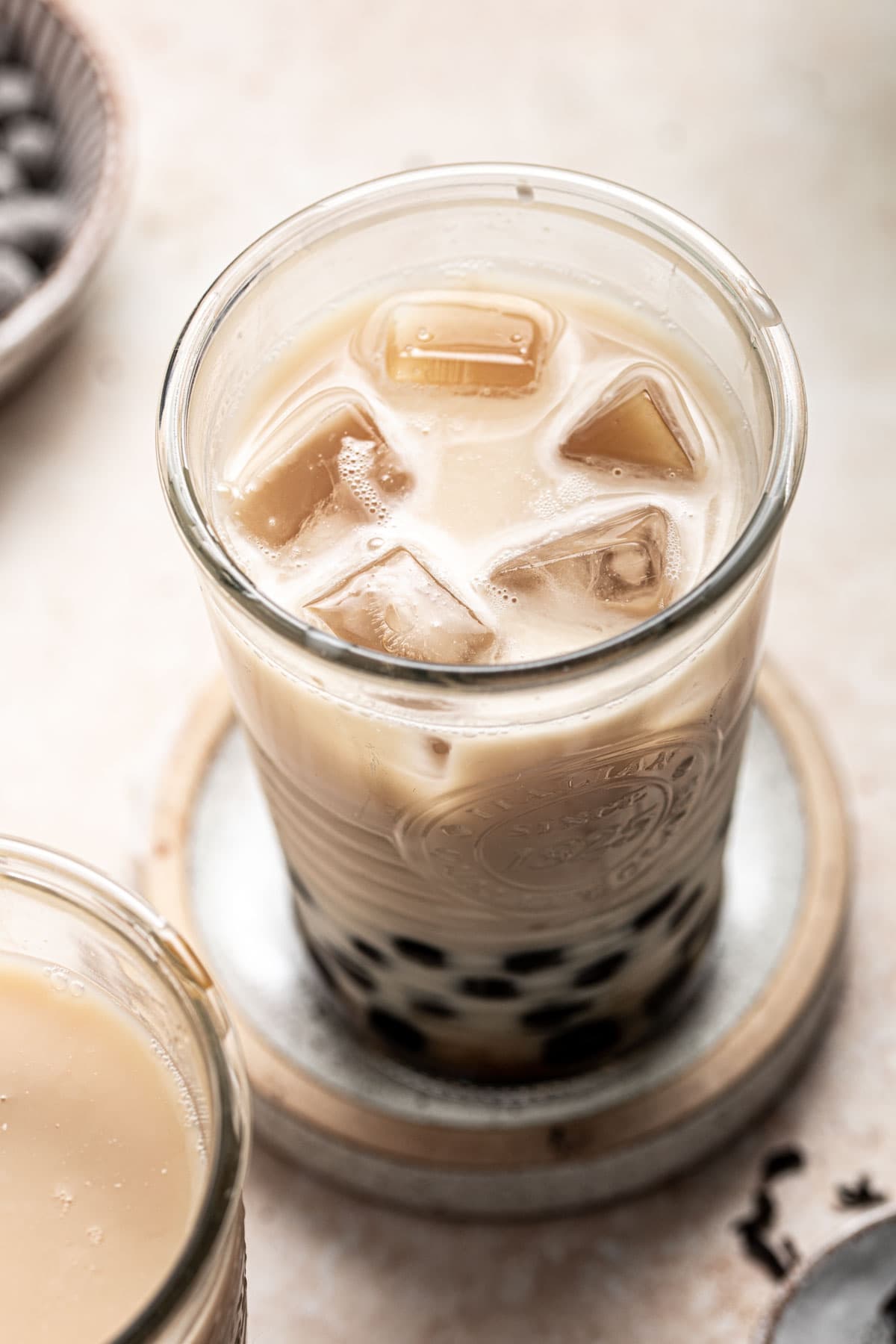 A close-up image of bubble tea filled with ice cubes. 
