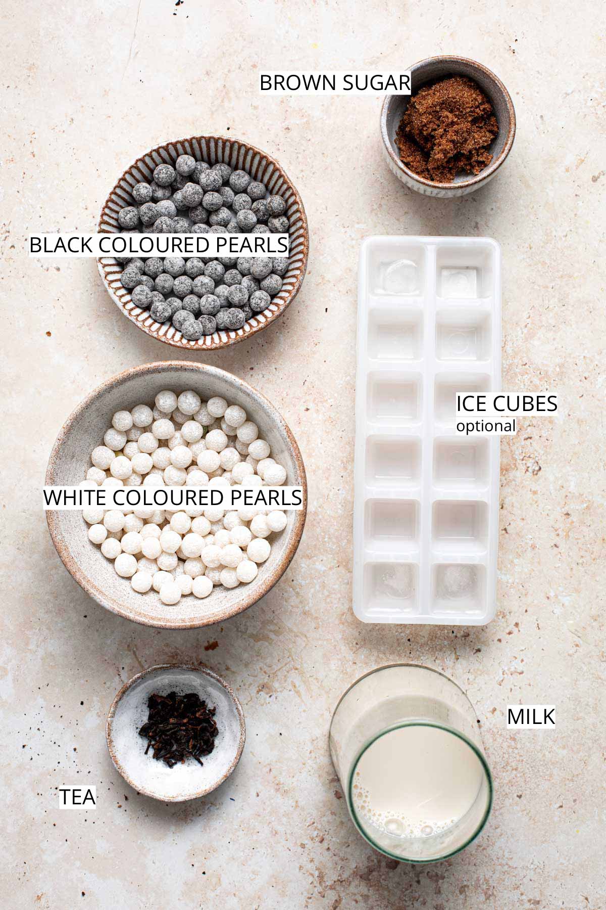 All ingredients needed to make panda milk tea on a flat surface.
