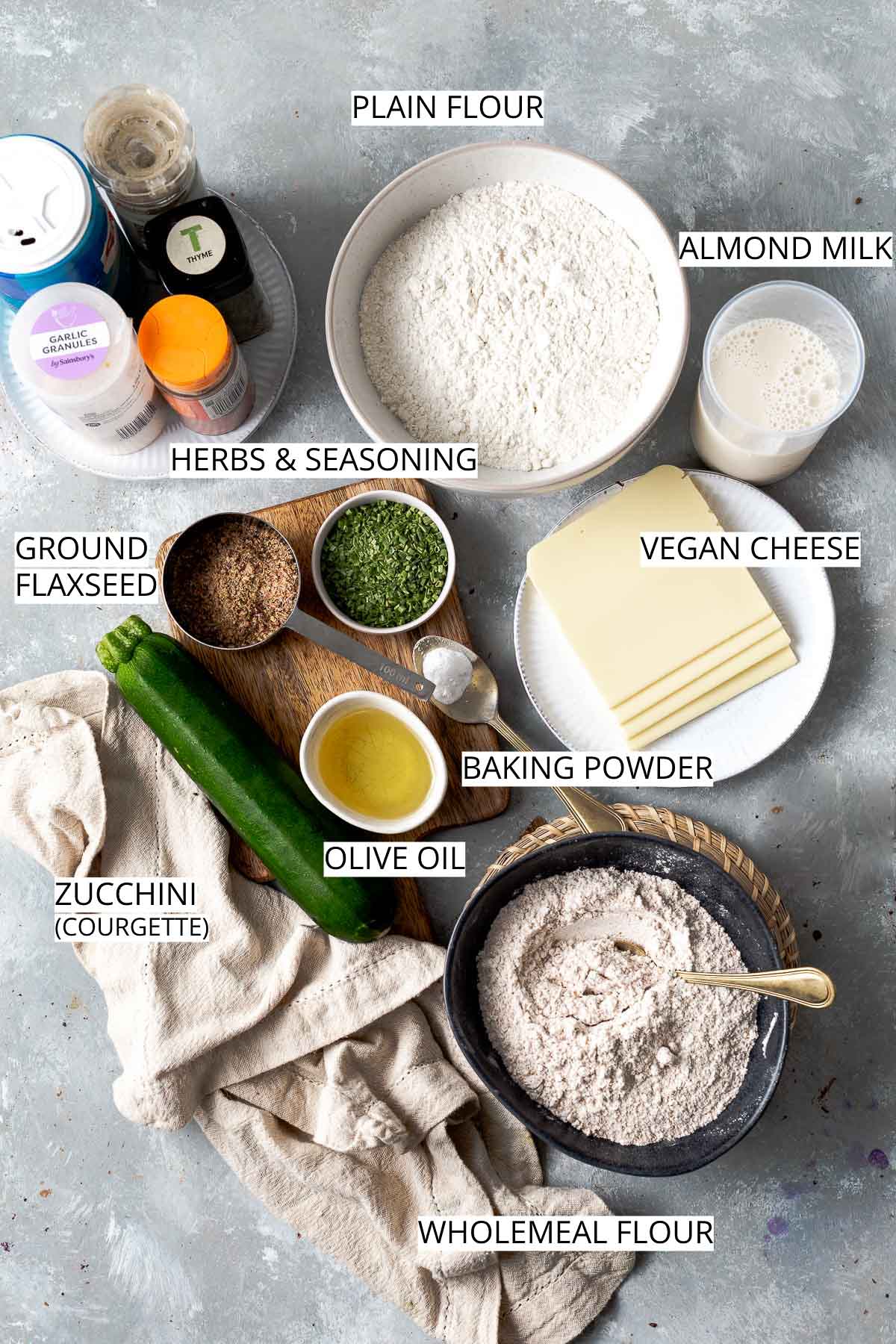 All ingredients needed to make a savoury muffin places in bowls on a flat surface. 