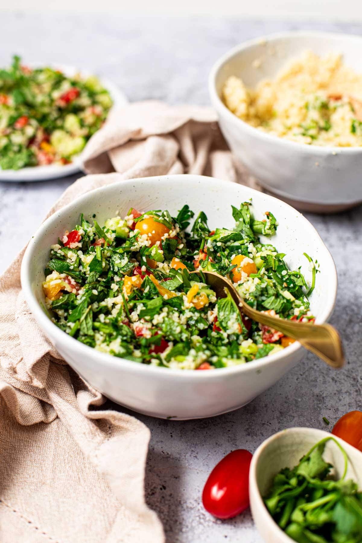 Side view of tabbouleh salad in a large white bowl.