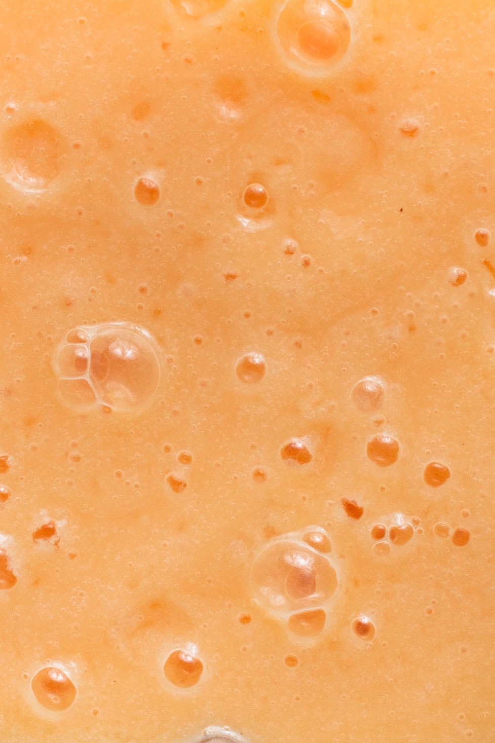 A very close-up view of papaya milk. 