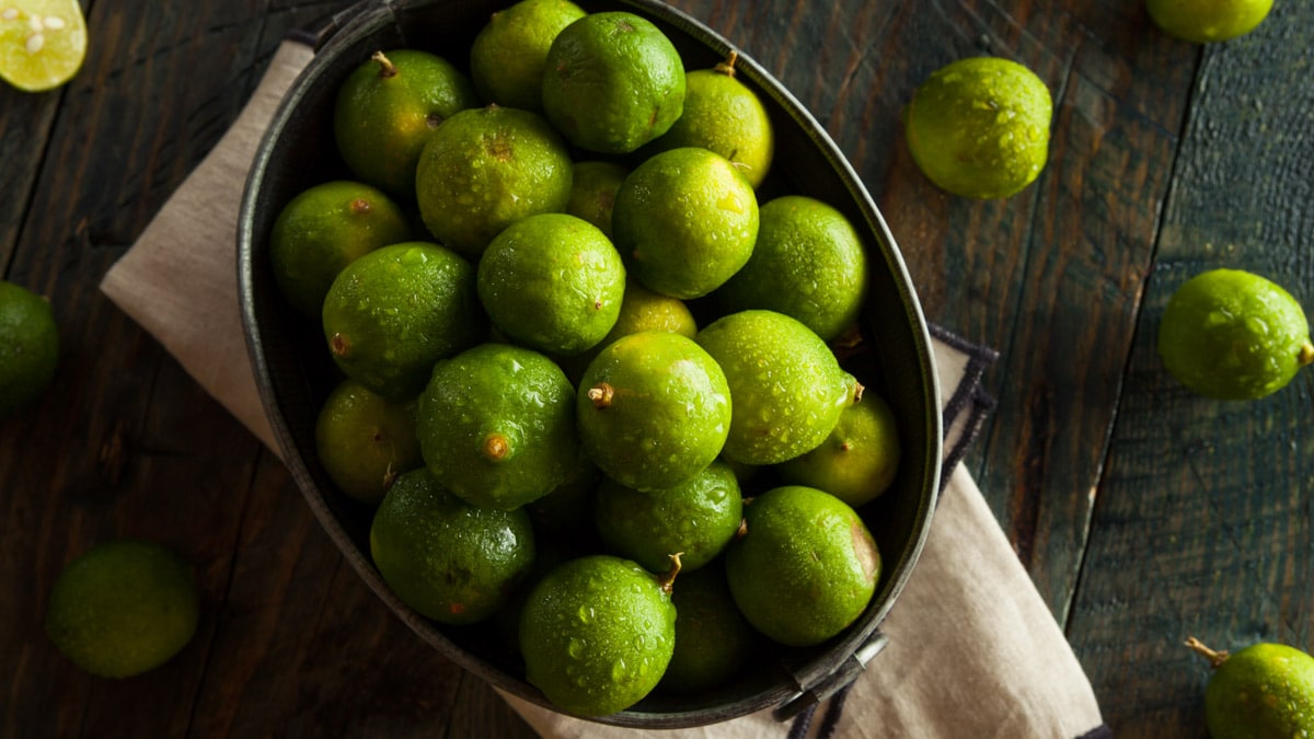 Raw Green Organic Key Limes in a Bowl.