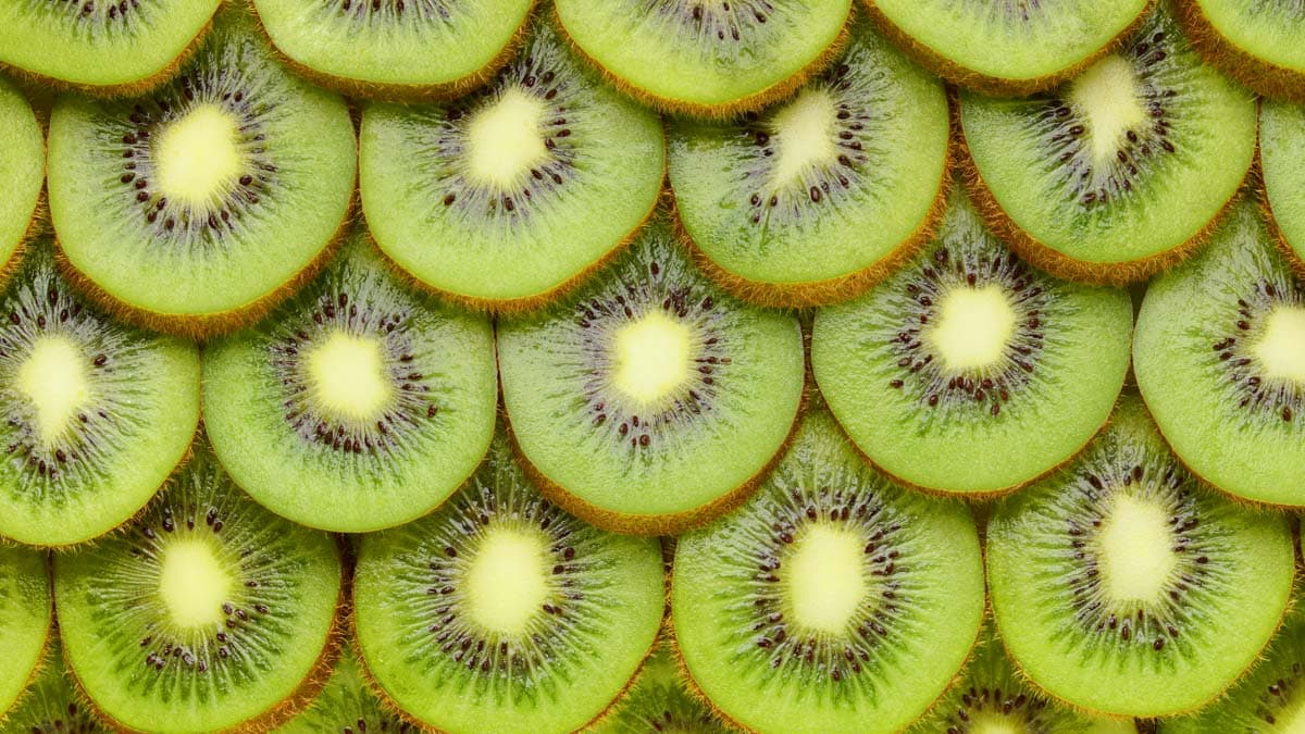 Kiwi fruit slices background or texture.