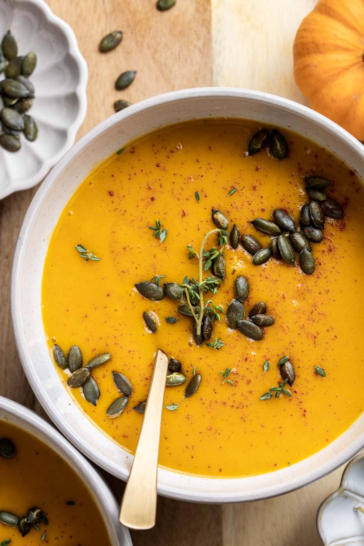 An overhead view of pumpkin soup in a bowl. 