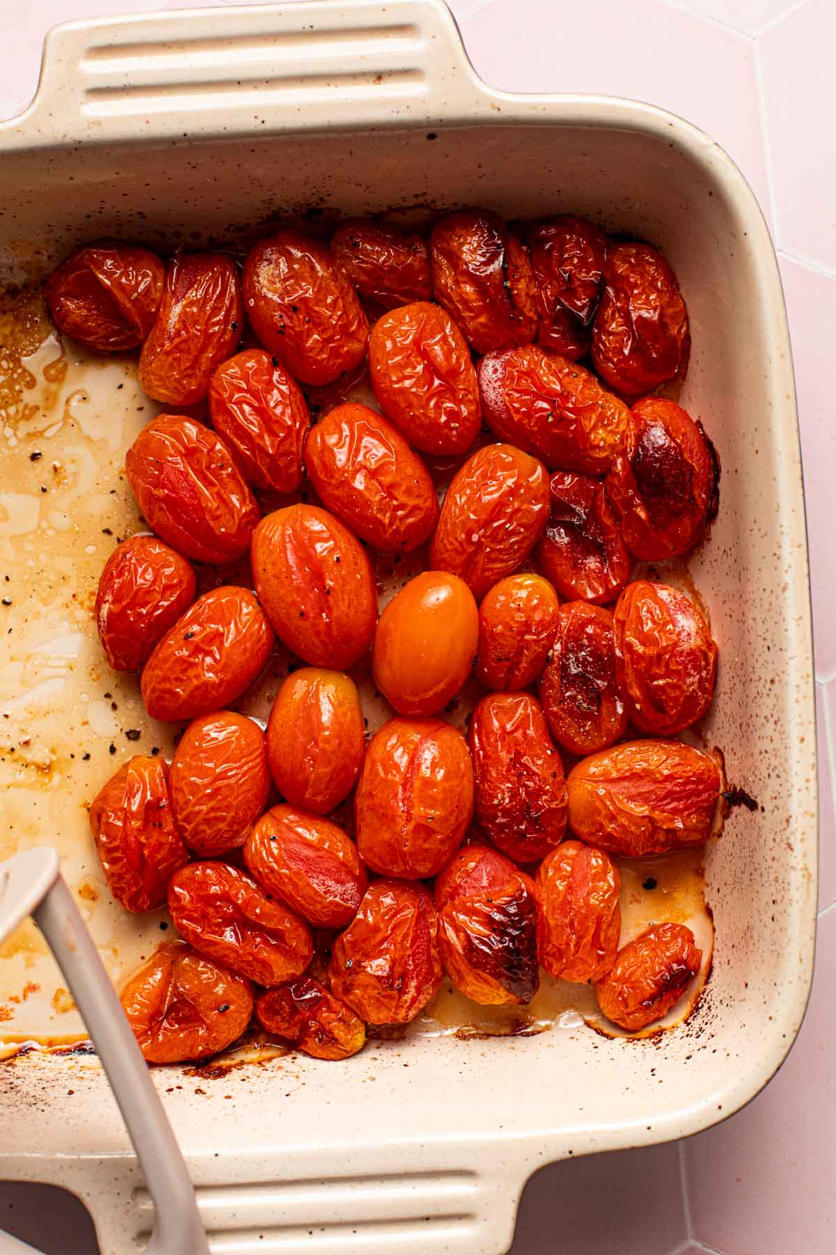 A close-up image of roasted baby plum tomatoes.