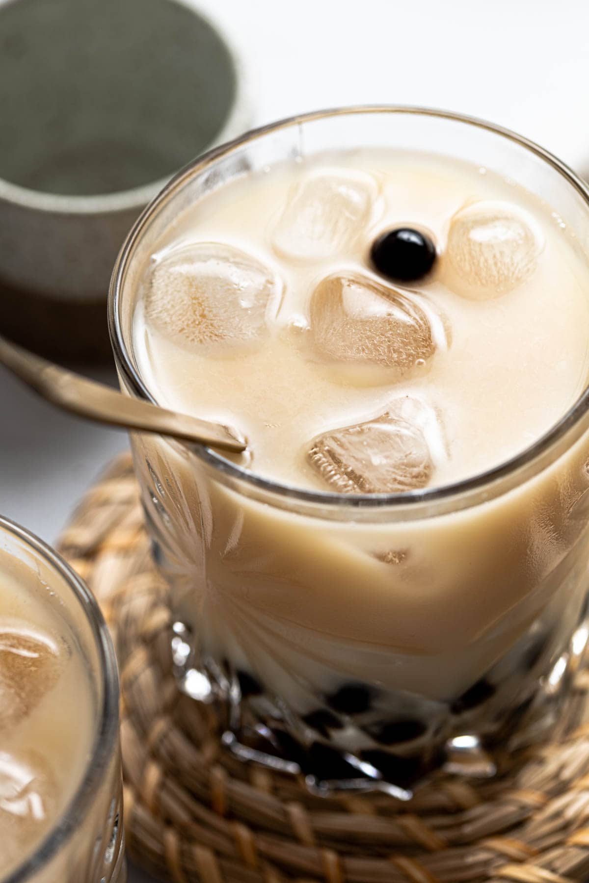 A side view of Earl Grey milk tea with ice. 