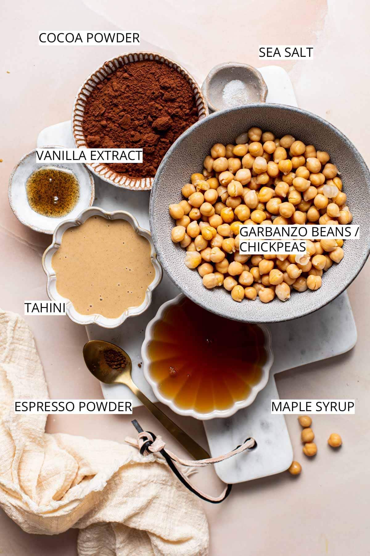 All ingredients needed to make dessert hummus laid on a marble board.